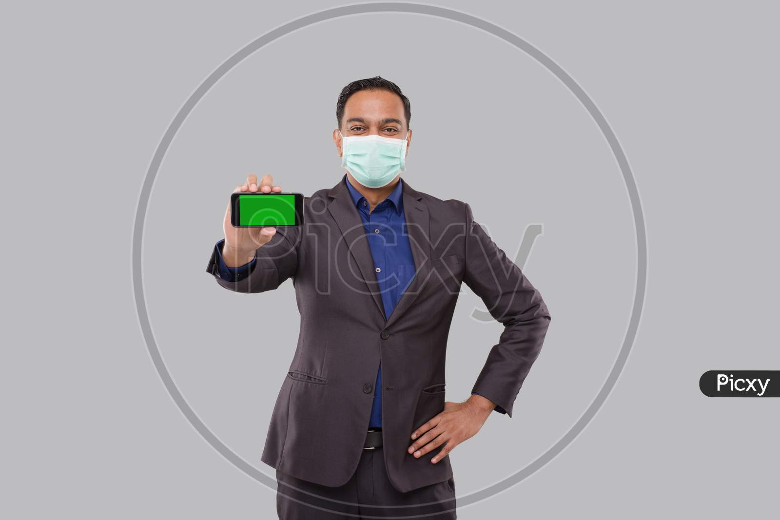 Businessman Showing Phone Holding Horizontal Wearing Medical Mask. Indian Business Man Technology Business At Home. Phone Green Screen Isolated