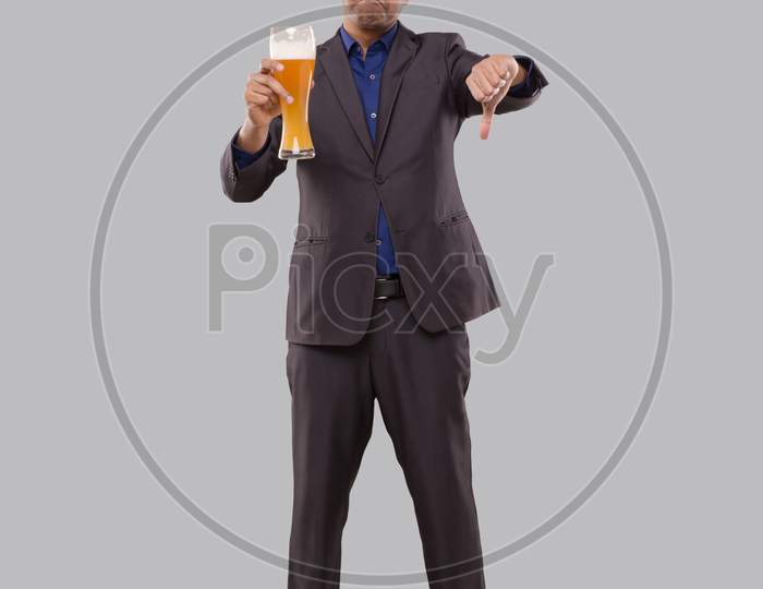 Businessman Holding Beer Glass Showing Thumb Down. Indian Business Man Standing Full Length With Beer In Hand