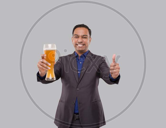 Businessman Holding Beer Glass Showing Thumb Up. Indian Business Man With Beer In Hand