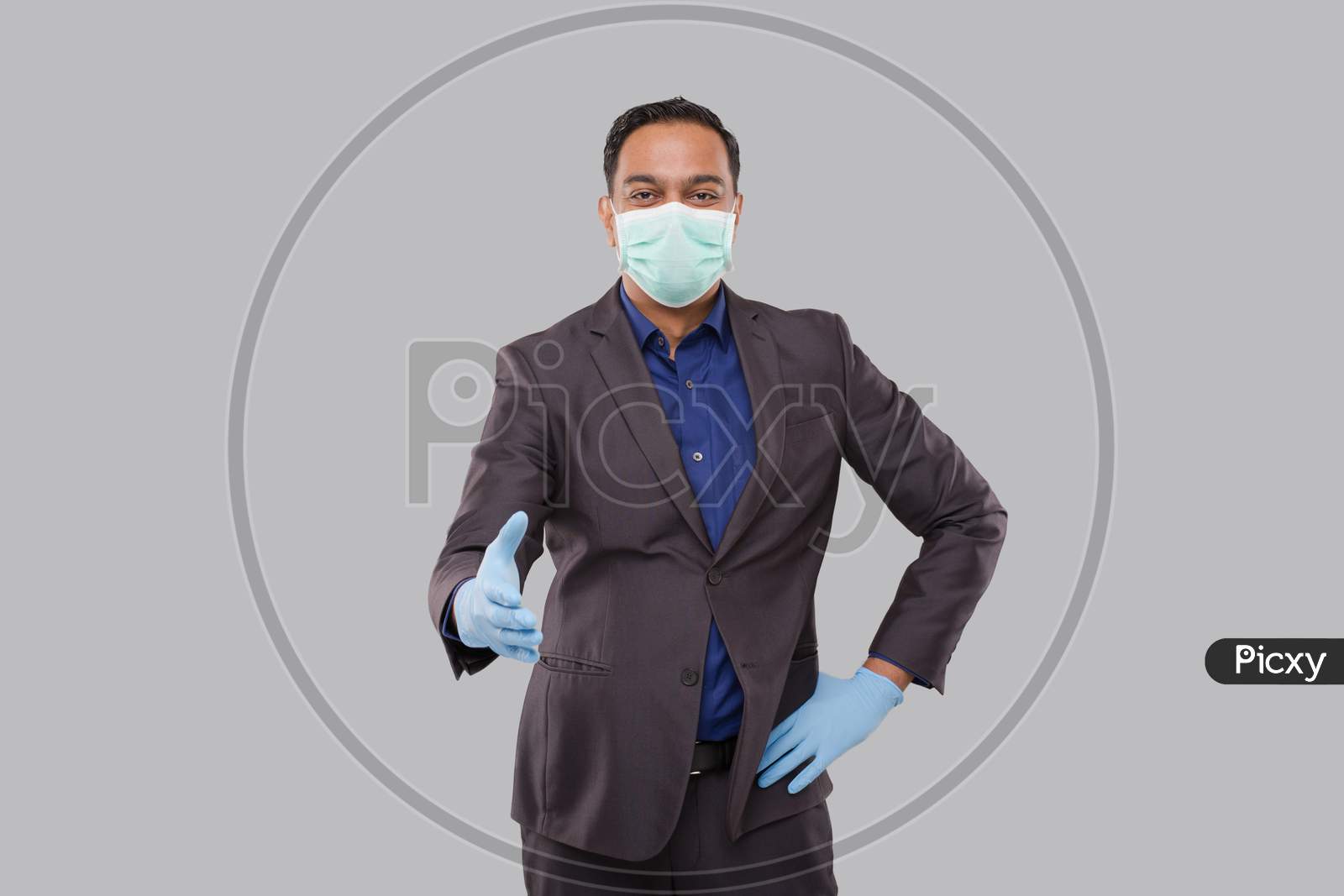 Indian Businessman Offering Hand To Shake Wearing Medical Mask And Gloves. Greeting And Welcoming Gesture. Business Advertisement Concept. Businessman Hand Shake