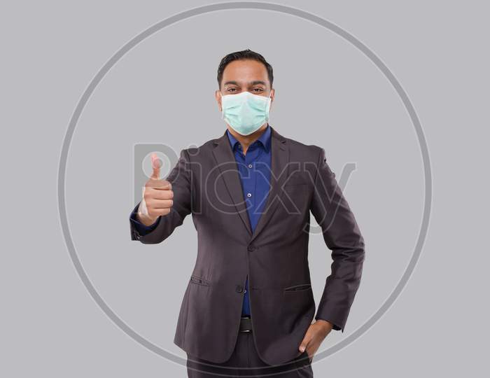 Businessman Showing Thump Up Wearing Medical Mask And Gloves Isolated. Indian Business Man Standing Thump Up Sign