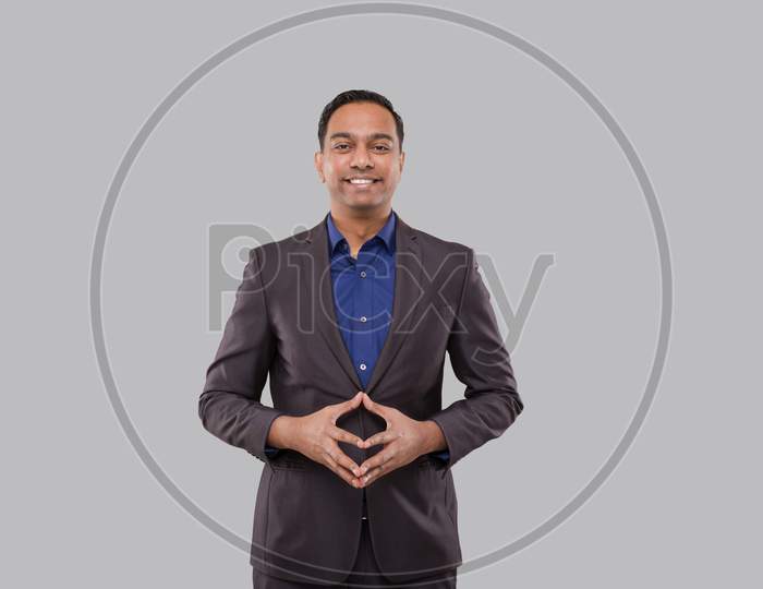 Businessman Smilling Hands In Front Of Chest Isolated. Indian Business Man Standing Business Pose