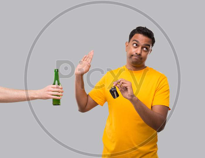 Indian Man Saying No To Beer Bottle Holding Car Keys. Dont Drink And Drive Concept. Man Doesnt Drink. No Alcohol. Man Refusing Alcohol