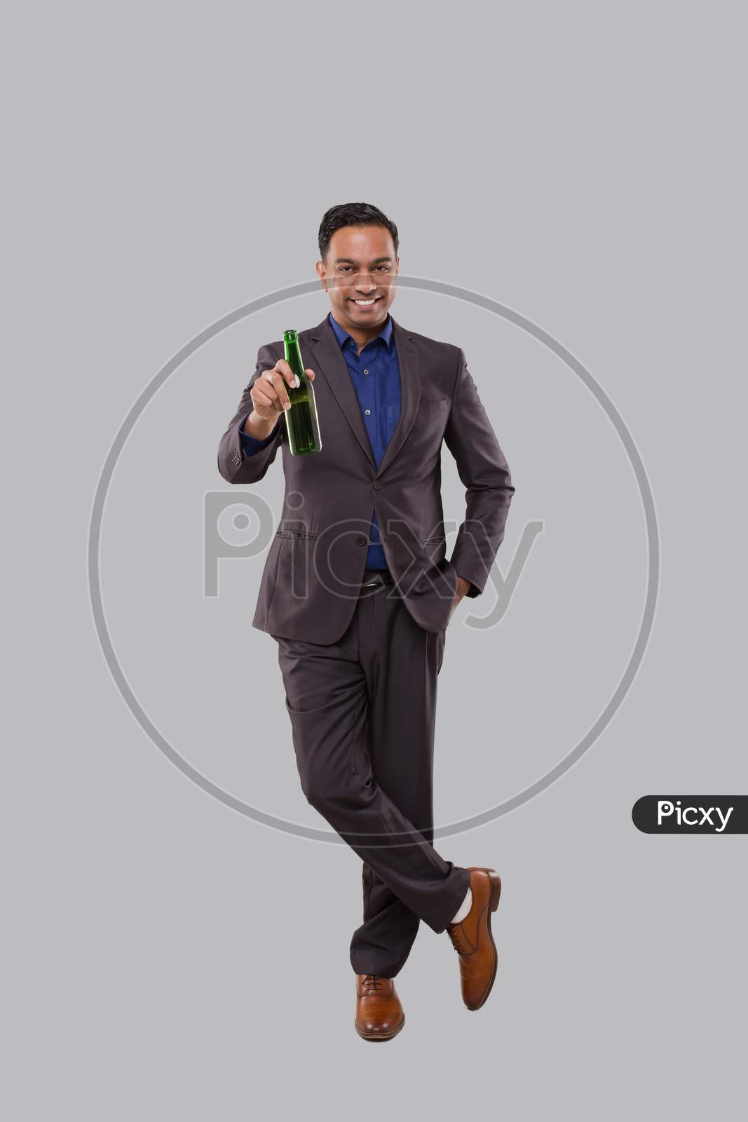 Businessman Holding Beer Bottle. Indian Businessman Standing Full Length.