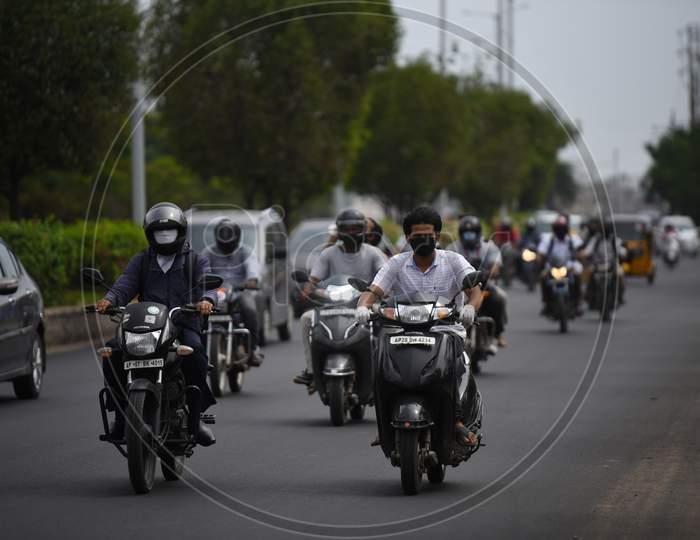 Motorists cover their faces with face masks, kerchief in Hyderabad.