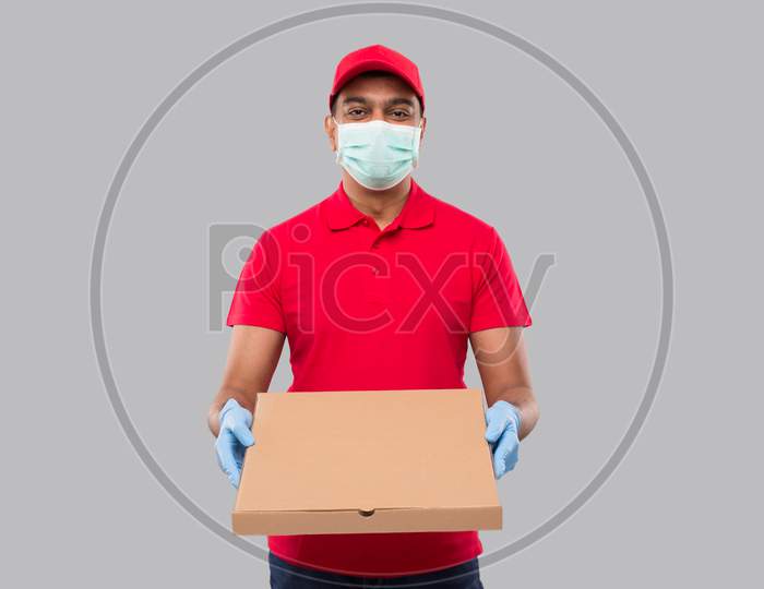 Delivery Man Pizza Box In Hands Wearing Medical Mask And Gloves Isolated. Red Tshirt Indian Delivery Boy.