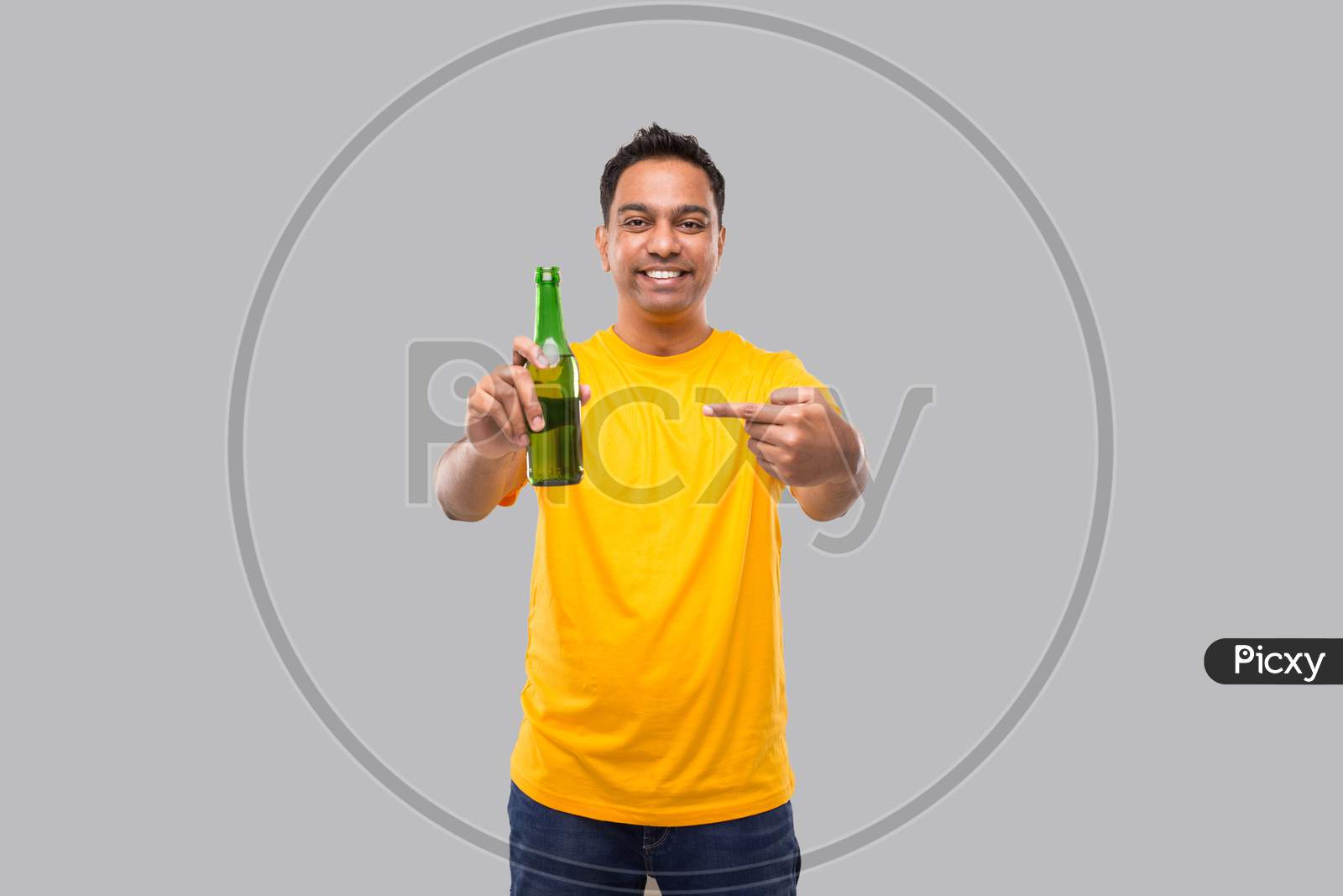 Indian Man Pointing At Beer From Beer Bottle Isolated.