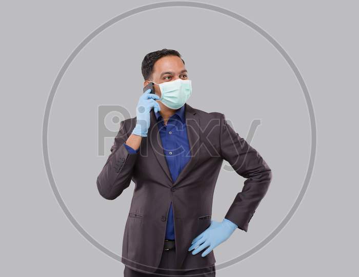 Businessman Talking On Phone Wearing Medical Mask And Glovesisolated. Indian Business Man With Phone In Hand