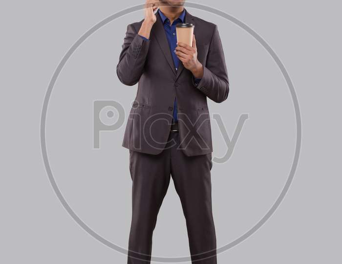 Businessman Talking On Phone With Coffee To Go Cup Isolated. Indian Business Man With Coffee Take Away Cup Standing Full Length