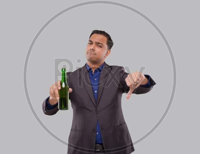 Businessman Holding Beer Bottle Showing Thumb Down. Indian Business Man With Beer Bottle In Hand.