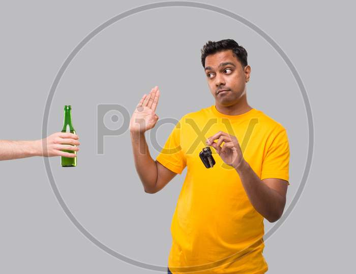 Indian Man Saying No To Beer Bottle Holding Car Keys. Dont Drink And Drive Concept. Man Doesnt Drink. No Alcohol. Man Refusing Alcohol
