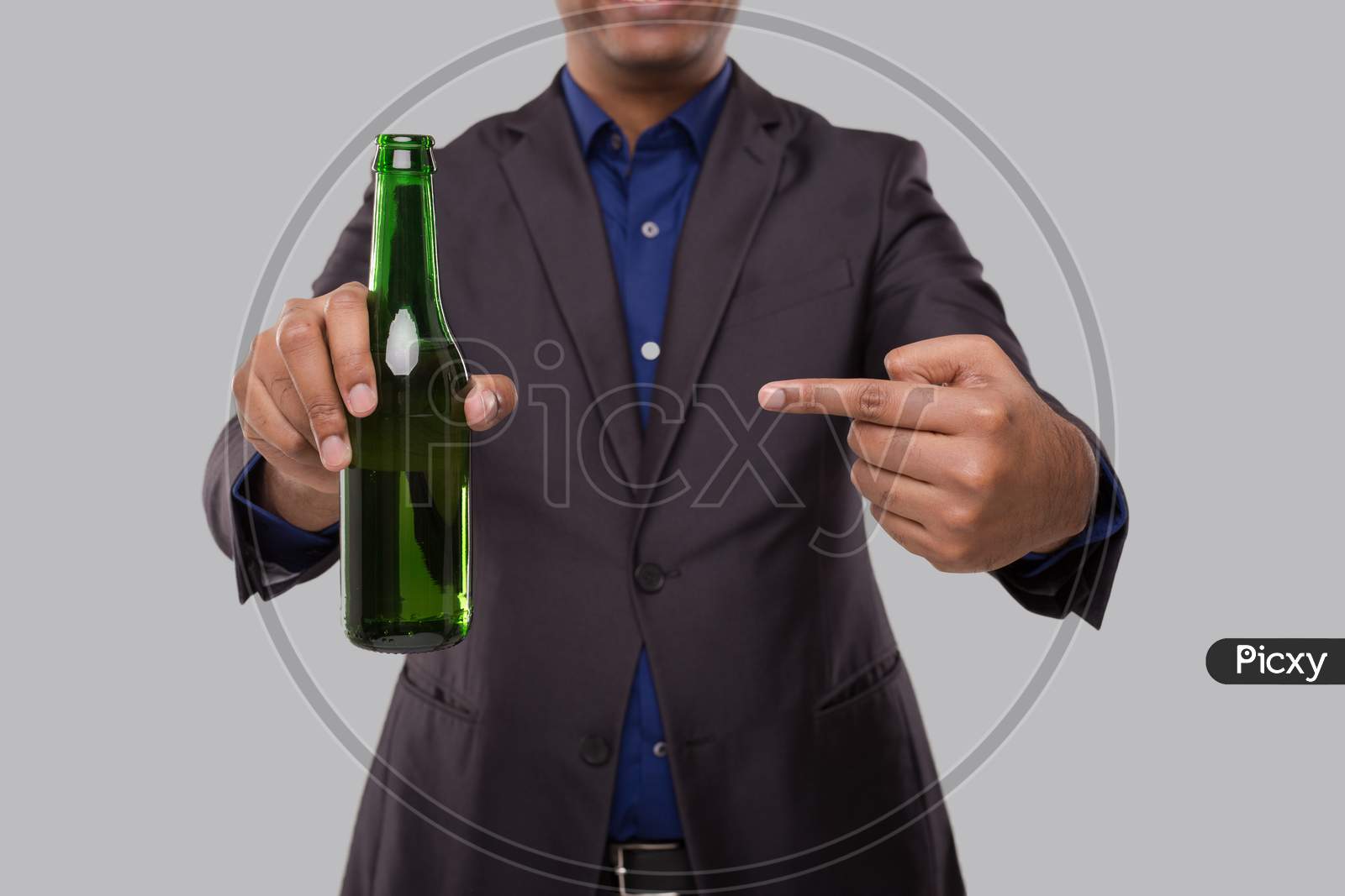 Businessman Pointing At Beer Bottle. Indian Business Man With Beer Bottle In Hand Close Up