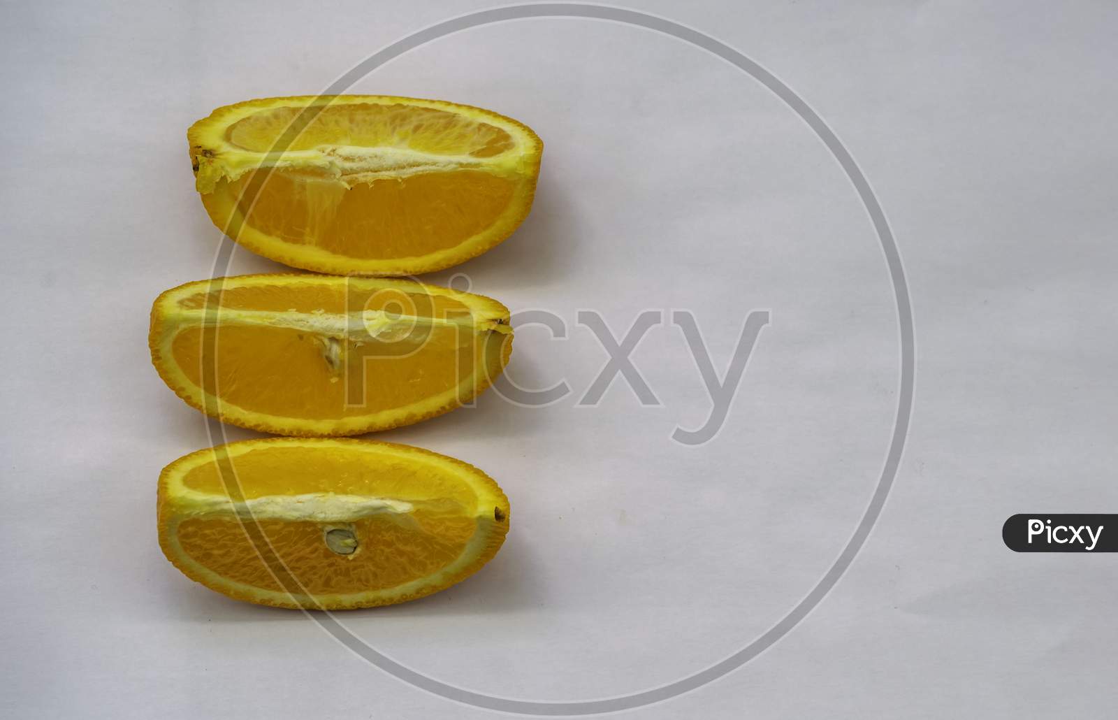 Three Orange Slices On A White Background, Selective Focus, Selective Focus On Subject,