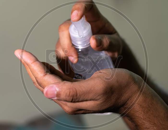 An Indian Man Taking Hand Sanitizer To His Hand To Prevent Corona Virus