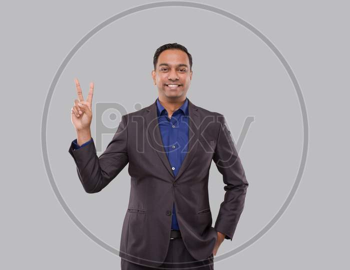 Businessman Showing Peace Sign Isolated. Indian Business Man Standing Smilling