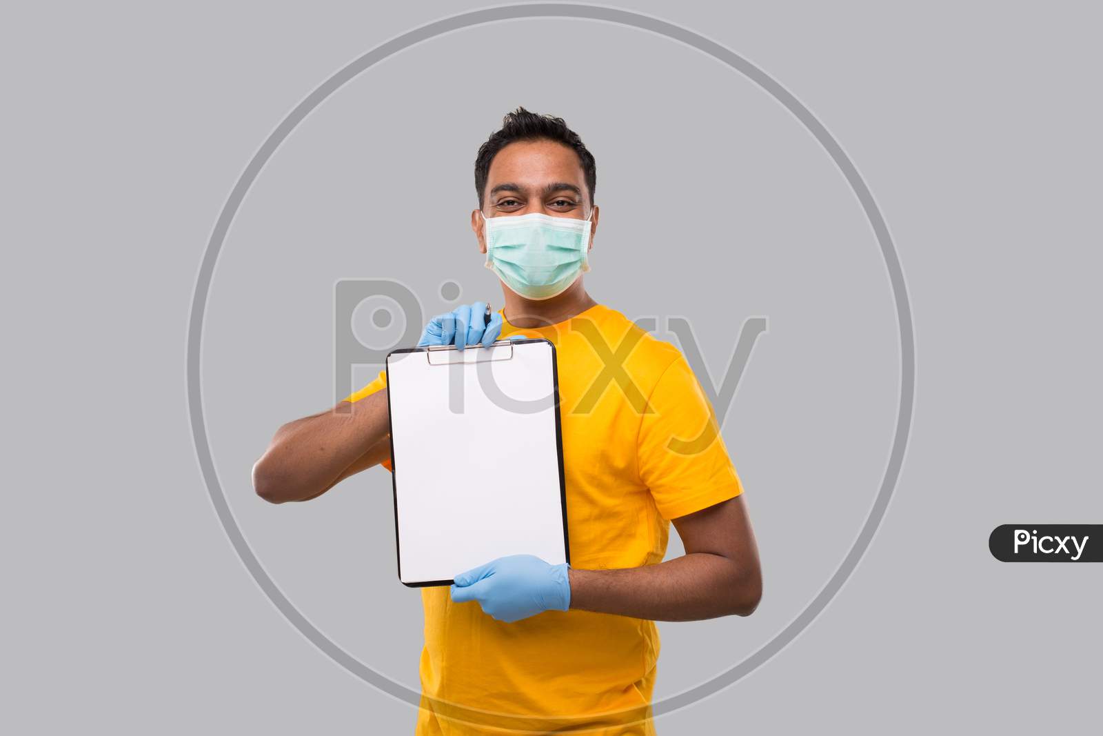 Indian Man Holding Clipboard Wearing Medical Mask And Gloves Watching In Camera. Indian Delivery Boy Clipboard