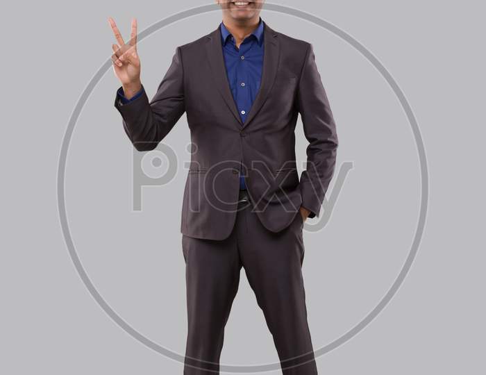 Businessman Showing Peace Sign. Indian Businessman Standing Full Length.