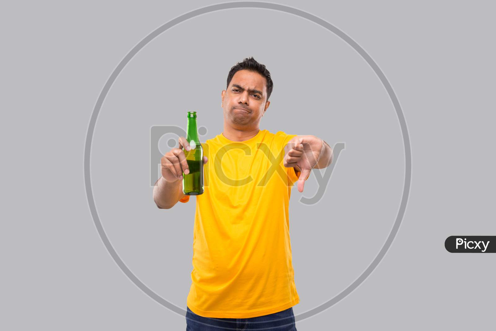 Indian Man Holding At Beer From Beer Bottle Showing Thumb Down Isolated.
