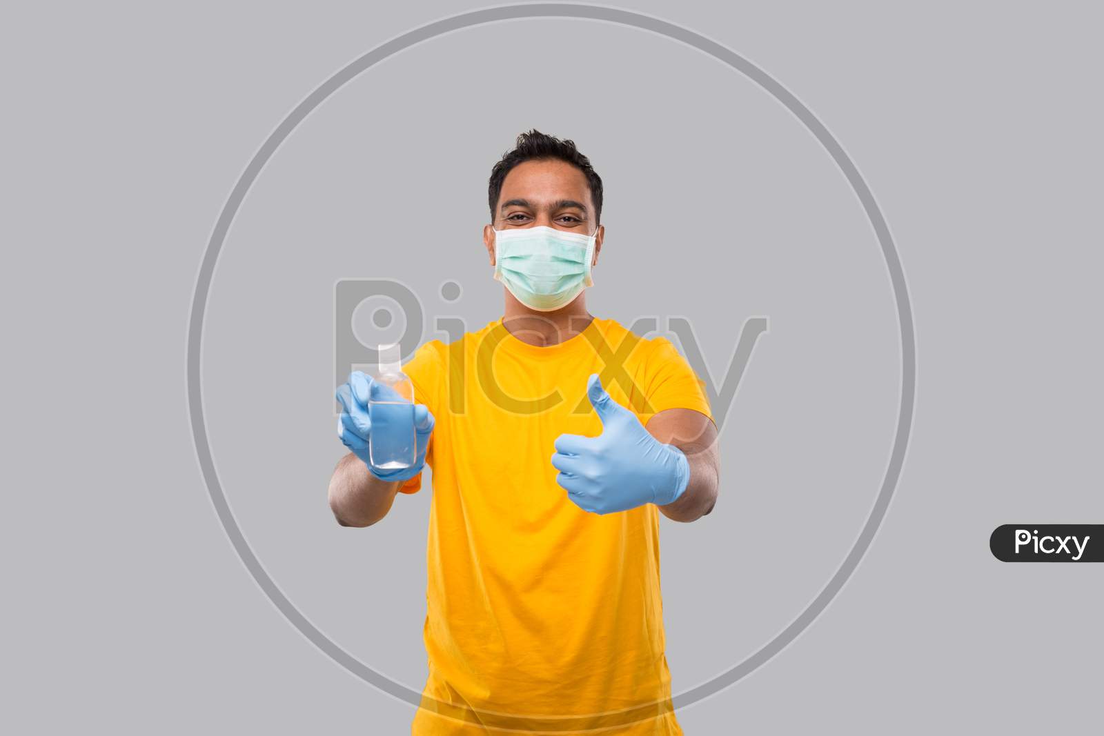 Indian Man Showing Hands Sanitizer And Thumb Up Wearing Medical Mask And Gloves Isolated. Indian Man Holding Hand Antiseptic