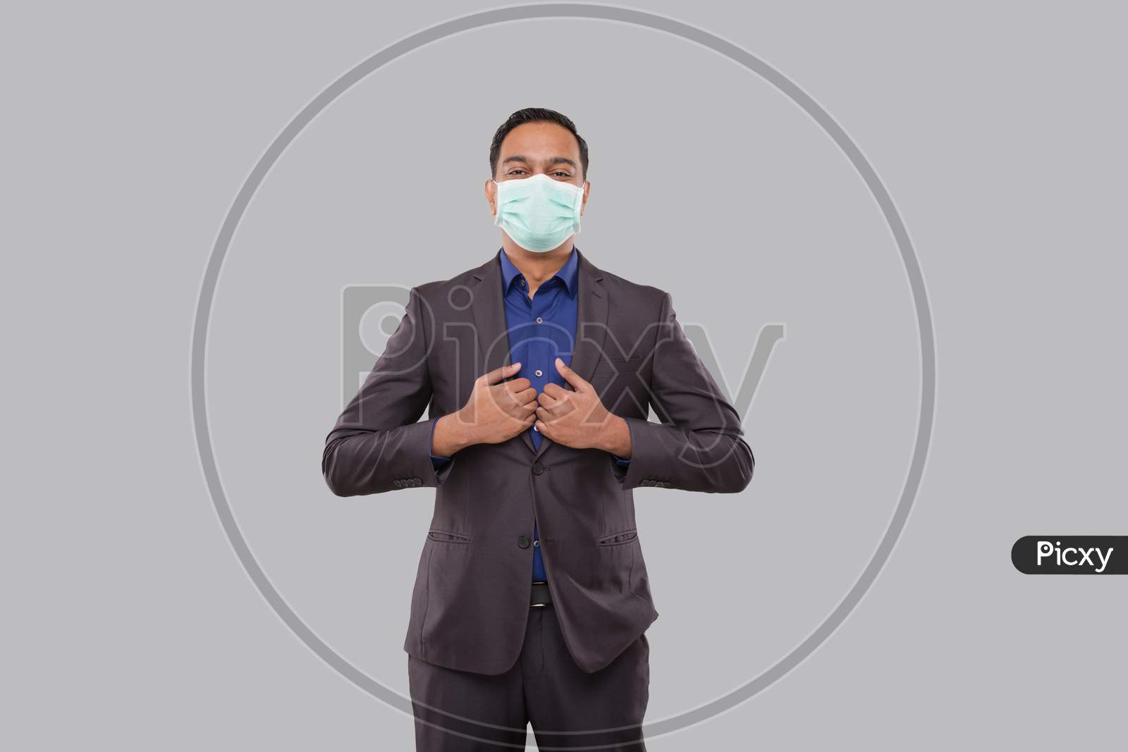 Businessman Standing In Business Pose Wearing Medical Mask Isolated. Indian Business Man Standing Isolated