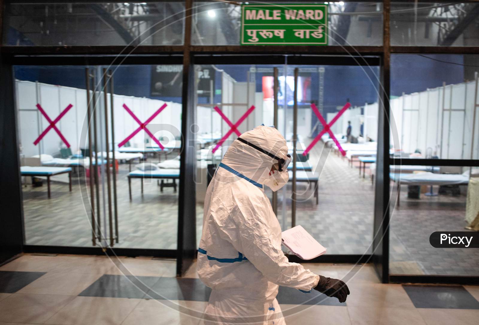 A doctor wearing a PPE kit takes rounds at the Common Wealth Games stadium which has been converted into a Coronavirus Care Centre in New Delhi on July 17, 2020