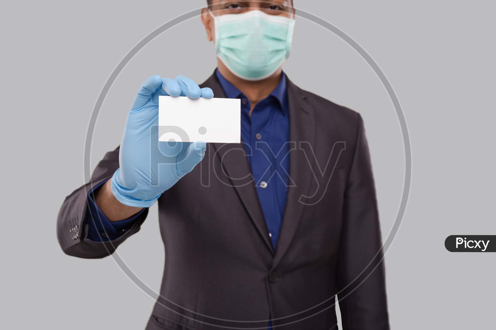 Businessman Showing Visit Card Wearing Medical Mask And Gloves Close Up Isolated. Indian Business Man Blank Card In Hand