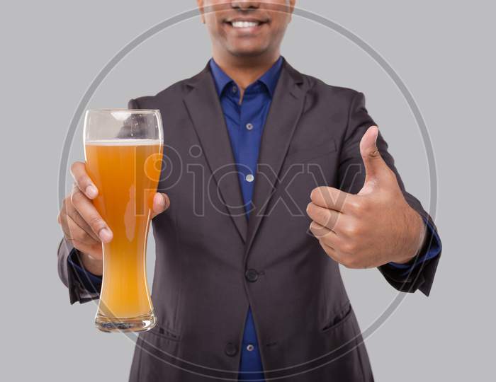 Businessman Showing Beer Glass And Thumb Up. Indian Business Man With Beer In Hand Close Up