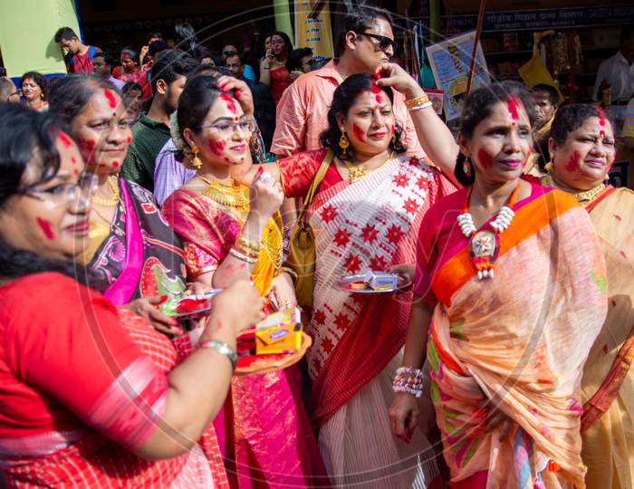 Holi Celebration and Durga puja Festival in Indian. Married and Unmarried women playing with vermilion or colors on vijay dashami at the bagbazar Durga puja,kolkata on 8th October 2019.