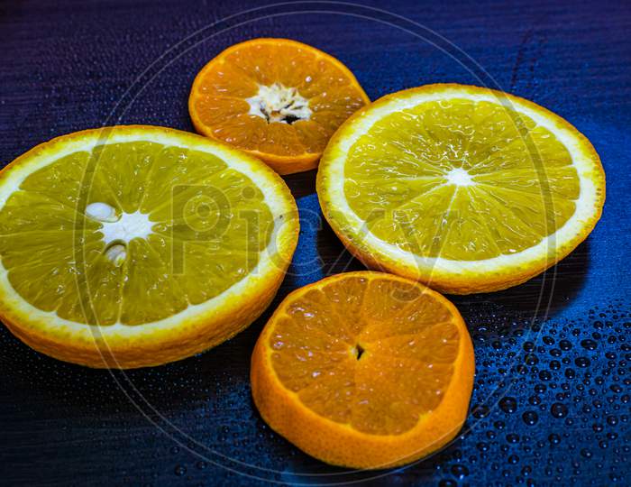 A Beautiful Close Up View Of An Orange Slice With Beautiful Background, Vitamin C, Covid 19A Beautiful Close Up View Of Wet Orange Slices With Beautiful Background, Vitamin C, Covid 19