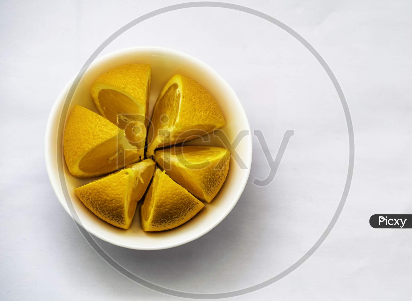 One Sliced Orange Arranged In A White Bowl, Selective Focus, Selective Focus On Subject,