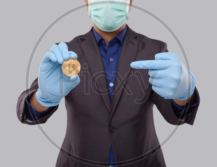 Businessman Pointing At Bitcoin Wearing Medical Mask And Gloves. Business Man Cypto Currency.