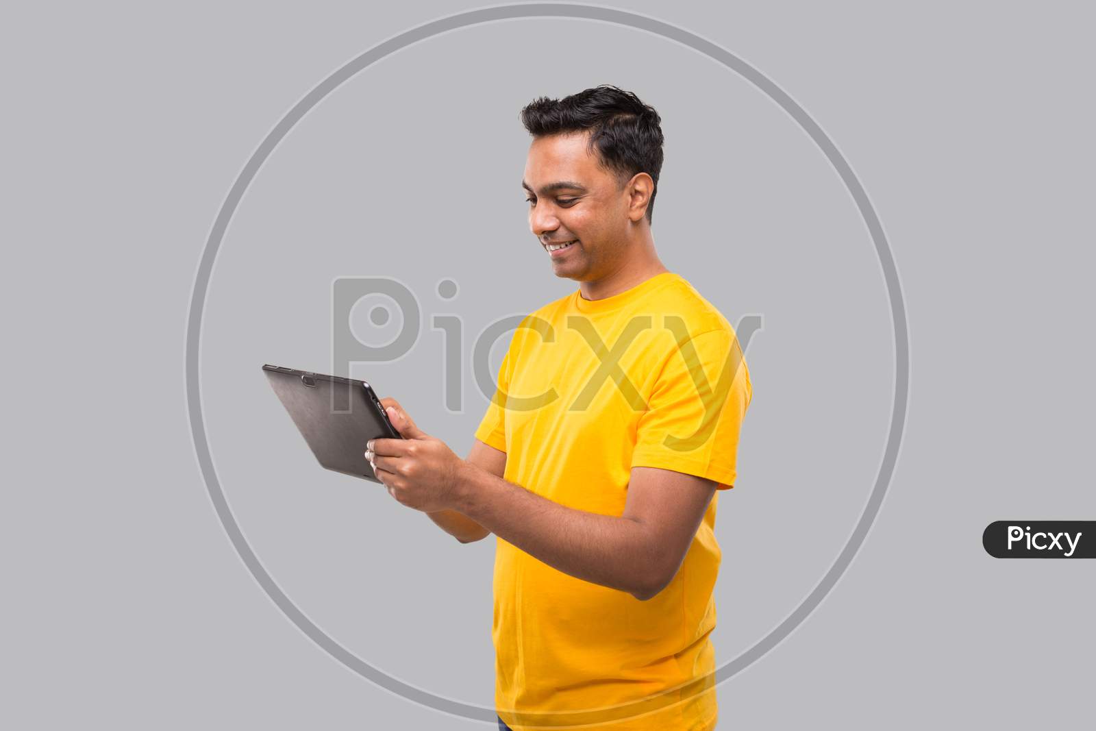 Indian Man Using Tablet. Indian Boy With Tablet In Hands. Home Delivery, Technical Delivery