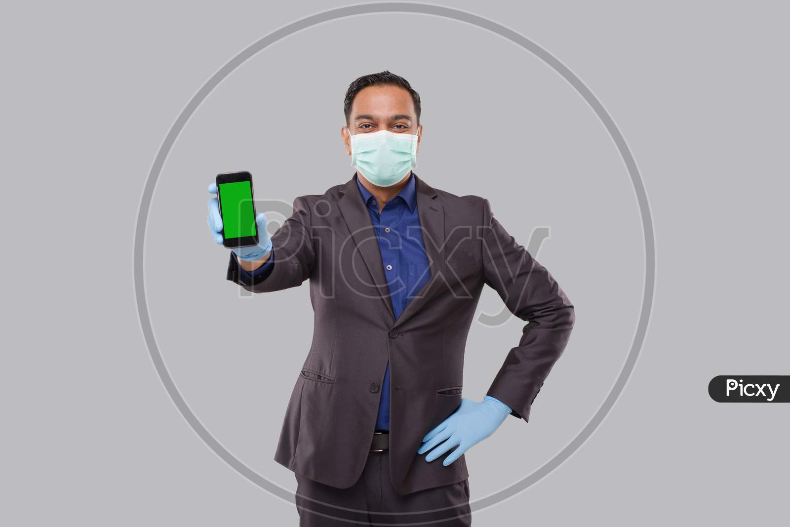 Businessman Showing Phone Wearing Medical Mask And Gloves. Indian Business Man Technology Business At Home. Phone Green Screen Isolated