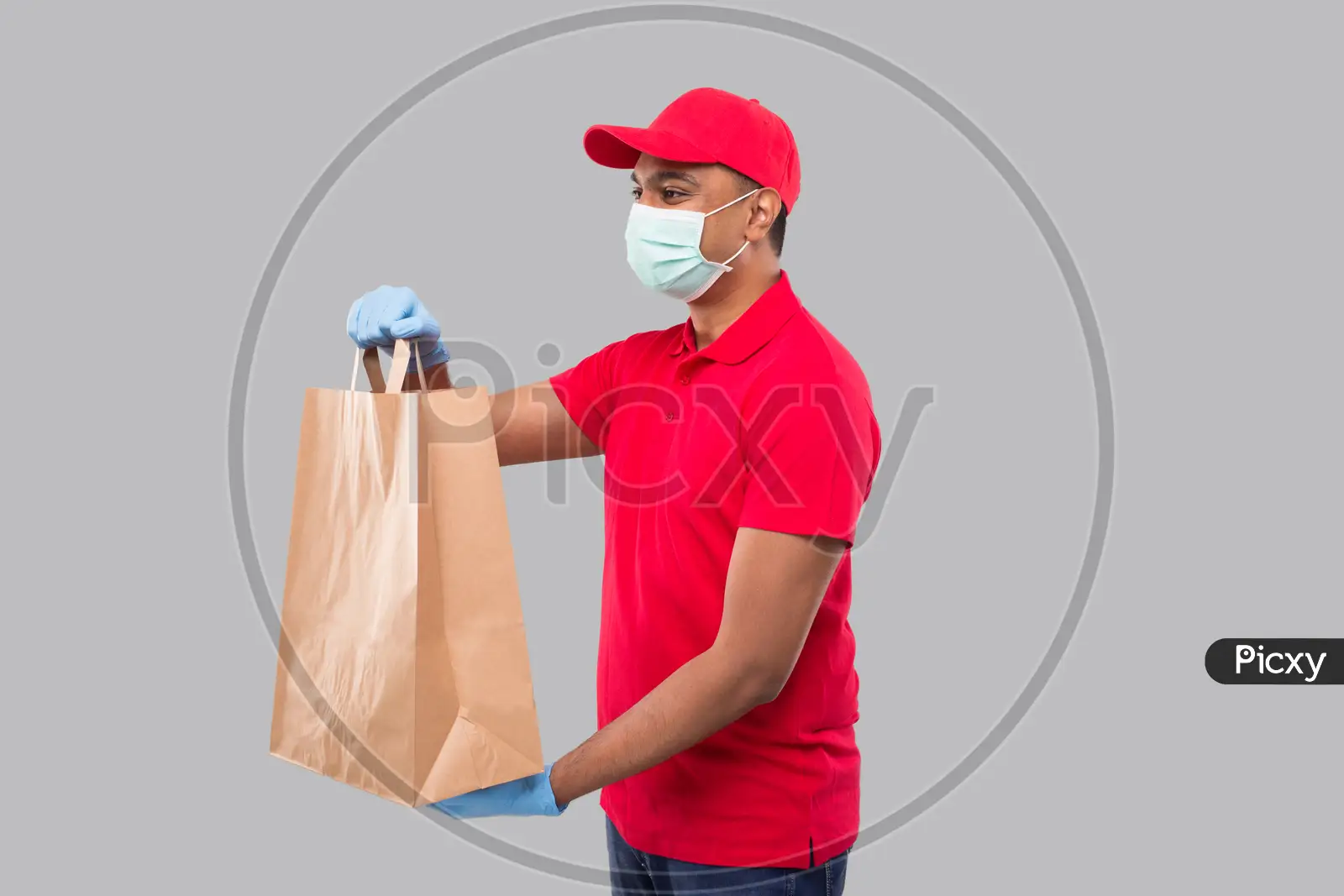 Asian Delivery Man Holding Shopping Bag In Medical Rubber Gloves