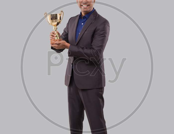 Businessman Holding Trophy. Indian Businessman Standing Full Length With Trophy In Hands