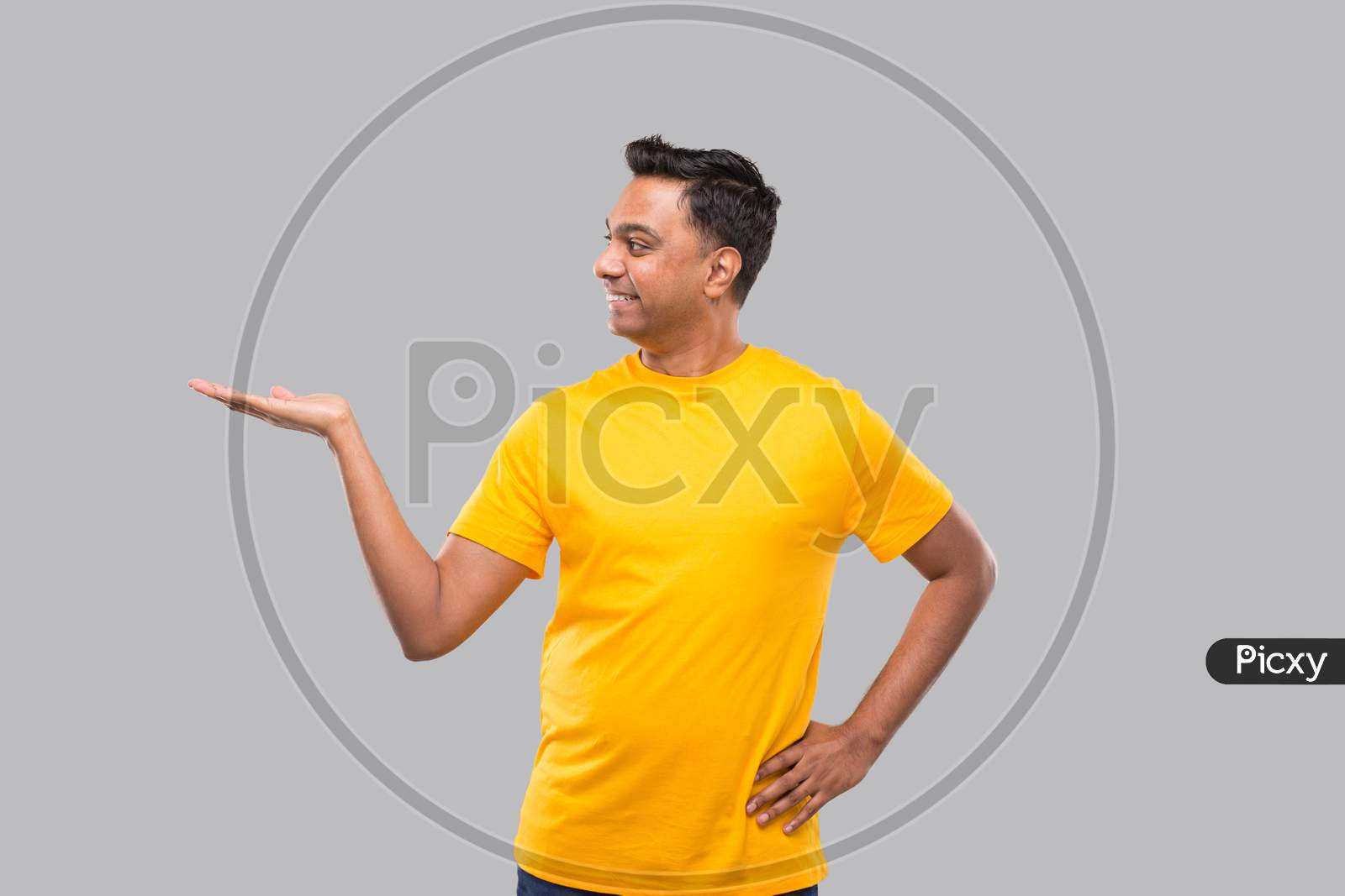 Indian Man Showing To Side Smilling Isolated.