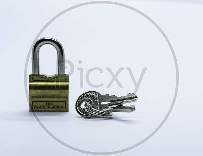 A Lock And Key On A Plain White Background.