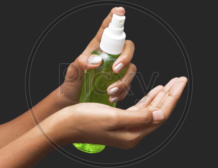 a lady sanitized her hands by alcohol hand sanitizer to avoid covid-19.