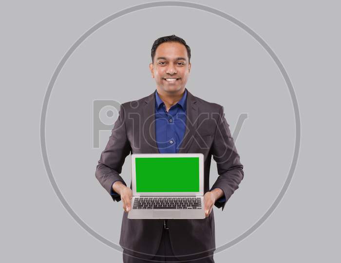 Businessman Showing Laptop Green Screen Isolated. Indian Business Man With Laptop In Hands. Online Business Concept