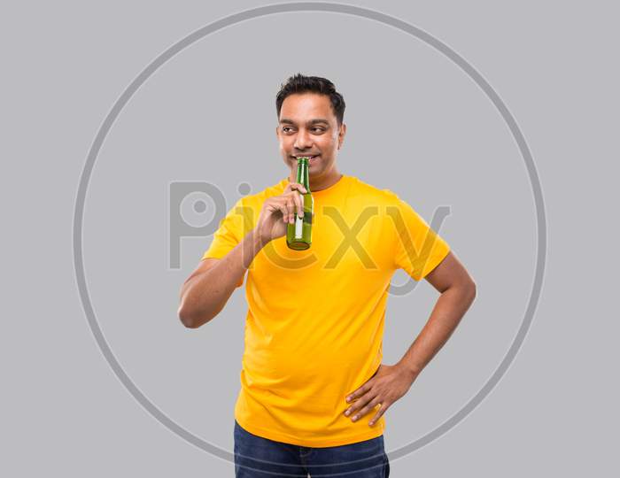 Indian Man Drinking Beer From Beer Bottle Isolated.