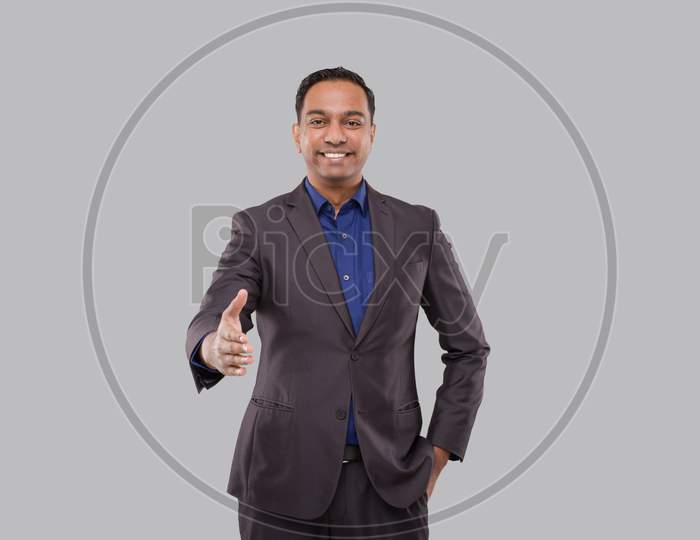 Indian Male Businessman Offering Hand To Shake. Greeting And Welcoming Gesture. Business Advertisement Concept. Businessman Hand Shake