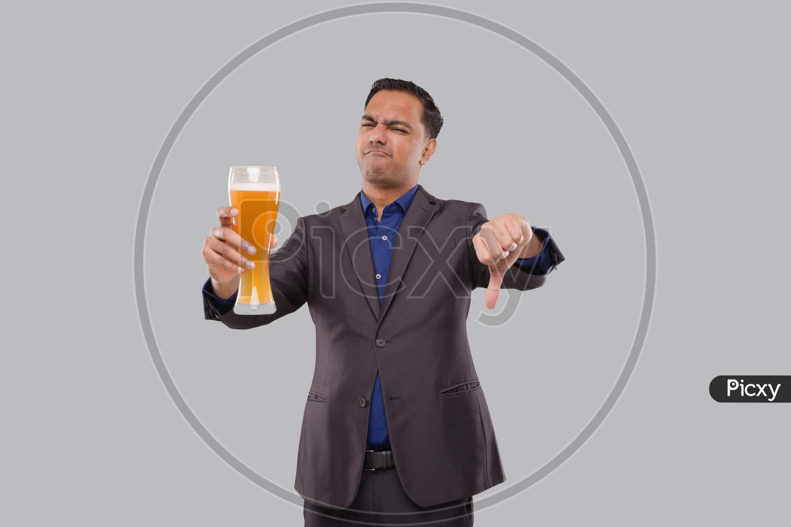 Businessman Holding Beer Glass Showing Thumb Down. Indian Business Man With Beer In Hand