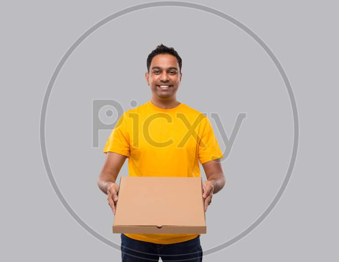 Delivery Man Pizza Box In Hands Isolated. Yellow Tshirt Indian Delivery Boy. Man With Pizza In Hands