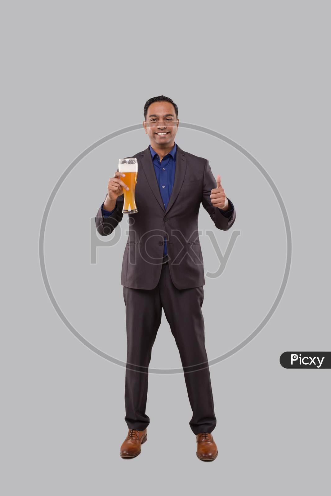 Businessman Holding Beer Glass Showing Thumb Up. Indian Business Man Standing Full Length With Beer In Hand