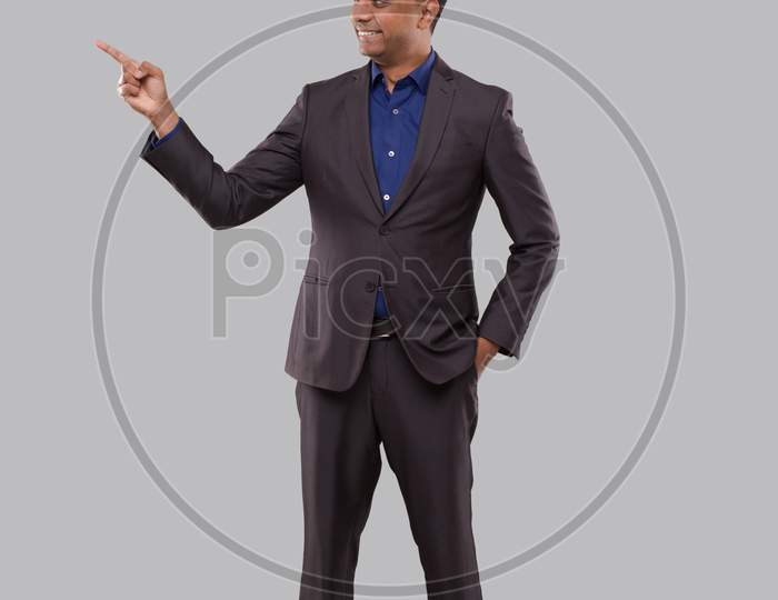 Businessman Pointing To Side Isolated. Indian Man Standing Full Lenght