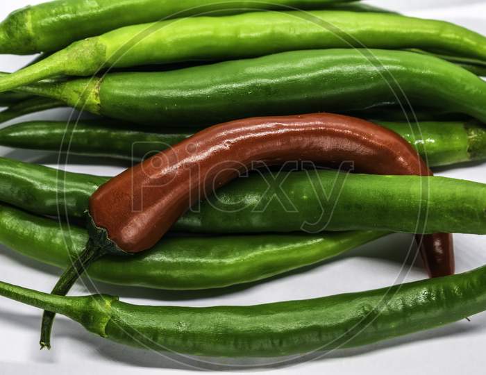 A Bunch Of Green And Red Chillies In White Background, Selective Focus, Selective Focus On Subject, Background Blur