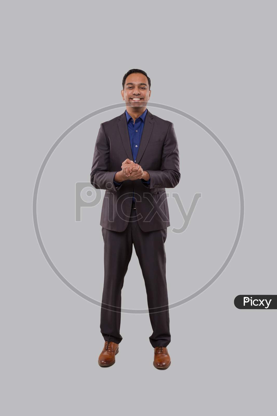 Businessman Smilling Hands In Front Of Chest Isolated. Indian Businessman Standing Full Length. Business Pose