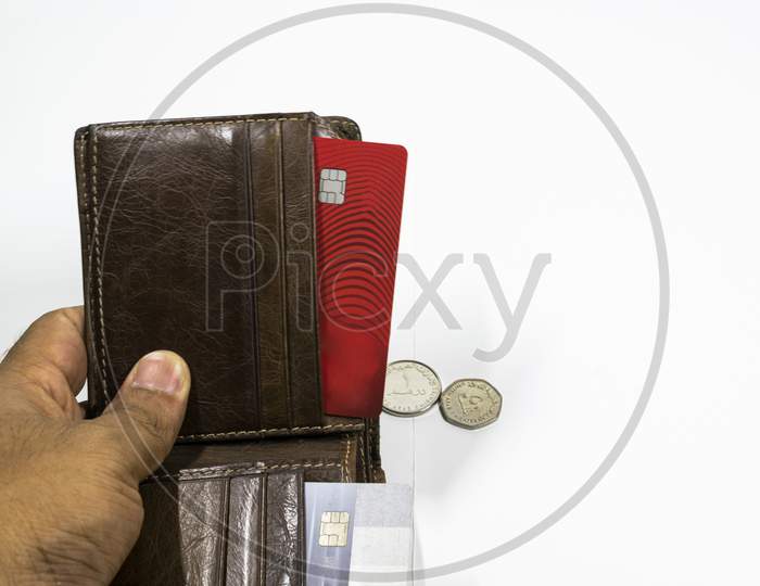 A Wallet And Credit Card With Uae Dirhams And Coins With White Background