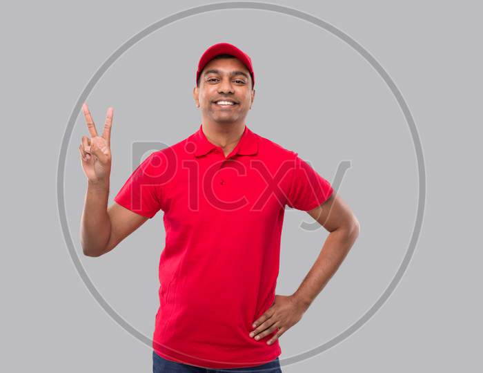 Delivery Man Showing Peace Sign Isolated. Indian Delivery Boy Smilling Peace