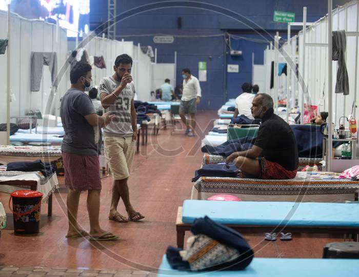 Patients tested positive for Coronavirus interact with each other while they are quarantined at Commonwealth Games Stadium which has been converted into a Coronavirus Care Centre in New Delhi on July 17, 2020